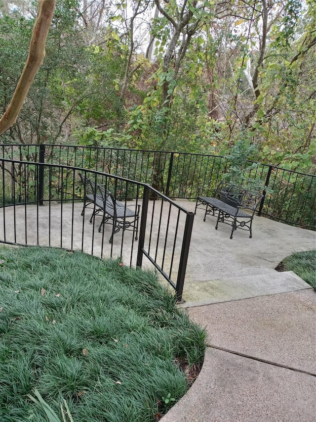 view of gate featuring a patio