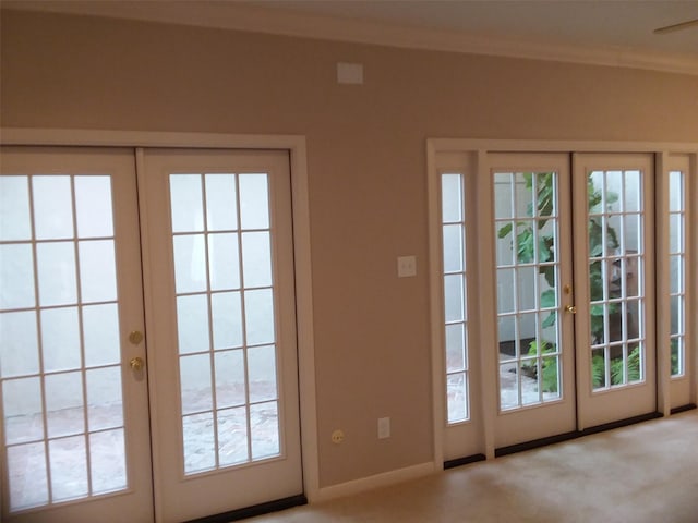 doorway to outside with a wealth of natural light, french doors, and light carpet