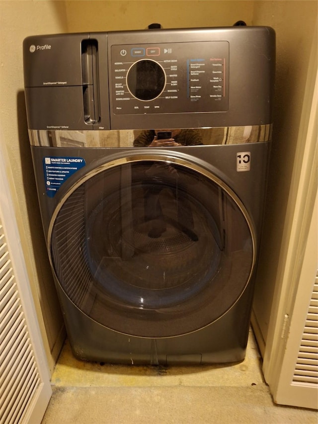 laundry area featuring stacked washing maching and dryer