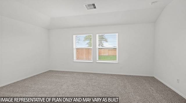 carpeted spare room featuring vaulted ceiling