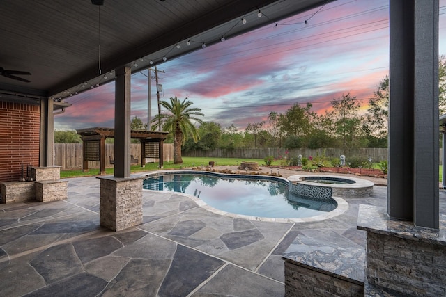 pool at dusk with an in ground hot tub, a pergola, and a patio