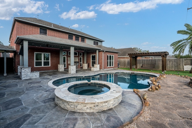 view of pool featuring an in ground hot tub, a patio area, and a pergola