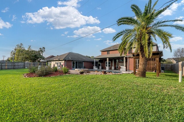 rear view of property featuring a patio area and a lawn