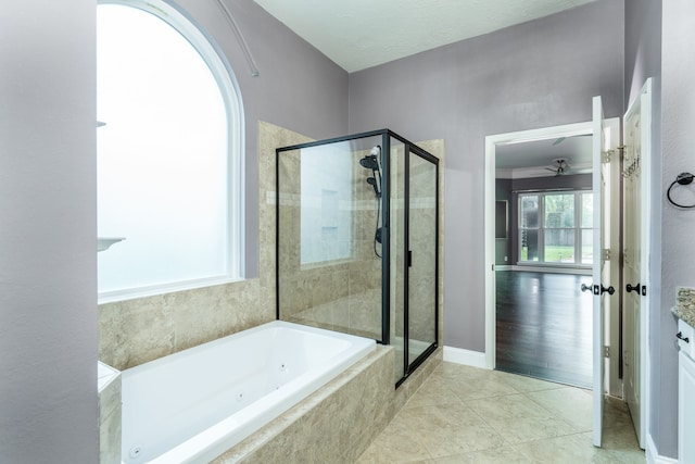 bathroom with tile patterned floors, vanity, and separate shower and tub