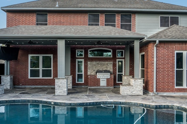 back of property with a patio area, an outdoor kitchen, and ceiling fan