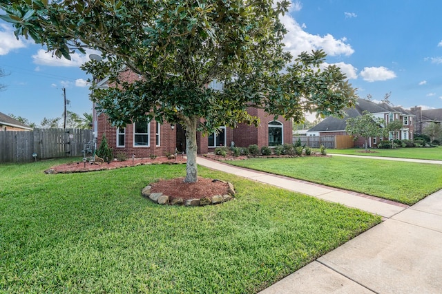 obstructed view of property featuring a front yard