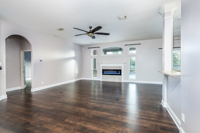 unfurnished living room featuring ceiling fan and dark wood-type flooring