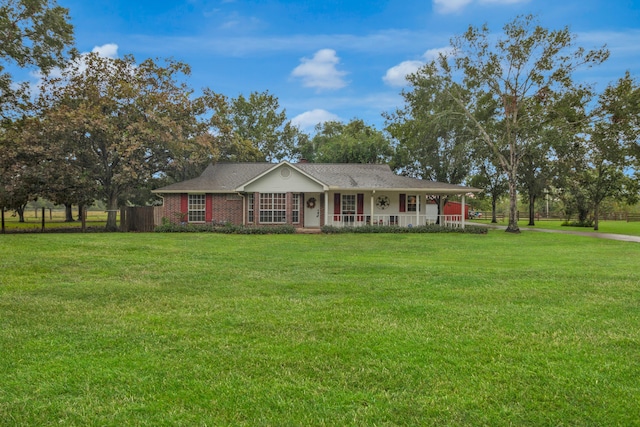 ranch-style house with a front yard and a porch