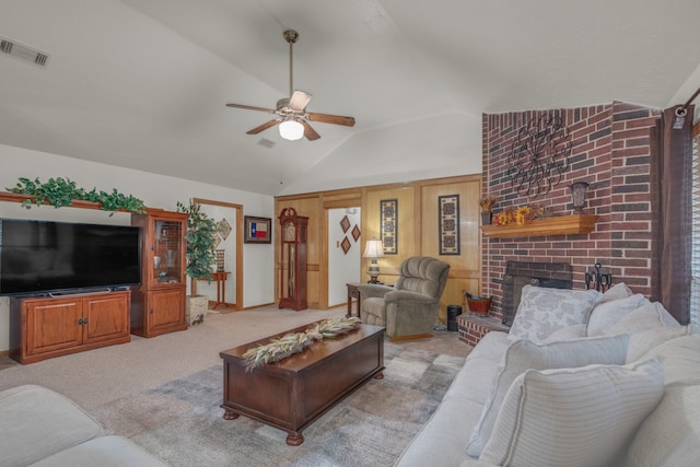 living room featuring a brick fireplace, ceiling fan, light carpet, and vaulted ceiling