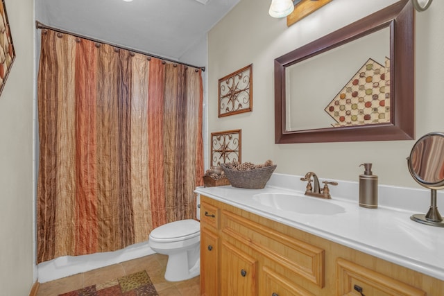 bathroom featuring toilet, vanity, and tile patterned flooring