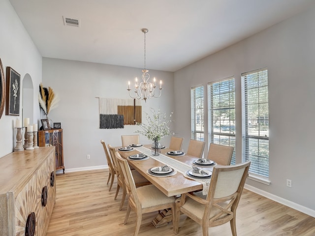 dining area featuring a chandelier and light wood-type flooring