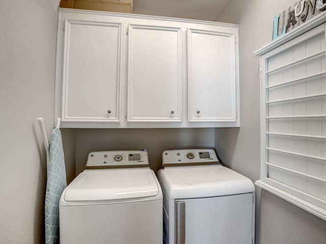 laundry room featuring cabinets and washer and dryer