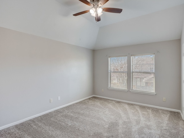 carpeted spare room with vaulted ceiling and ceiling fan