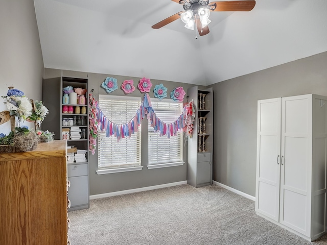 bedroom featuring light colored carpet, lofted ceiling, and ceiling fan