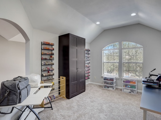 carpeted office space with lofted ceiling