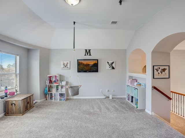 recreation room with lofted ceiling and light carpet