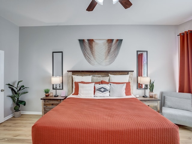 bedroom with light hardwood / wood-style floors and ceiling fan