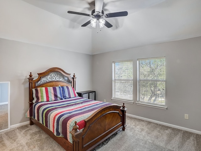 carpeted bedroom with ceiling fan and vaulted ceiling