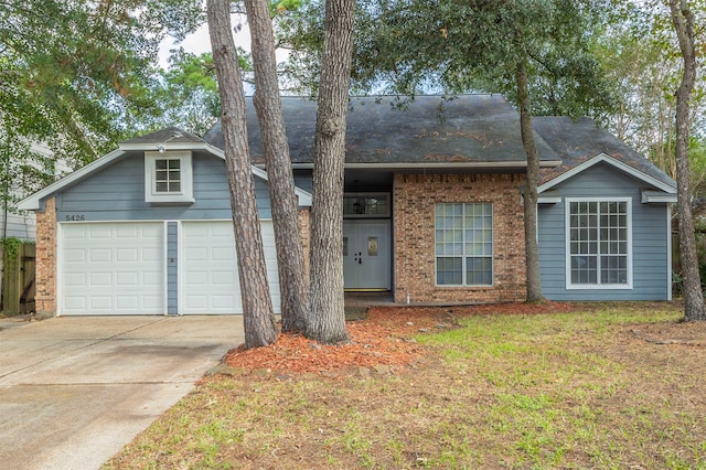 ranch-style house with a garage and a front yard