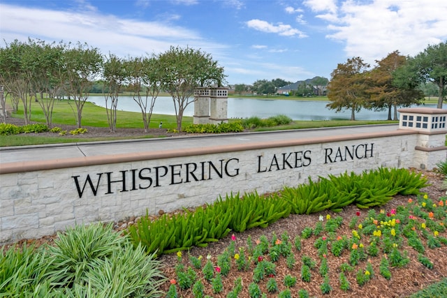 community sign featuring a water view