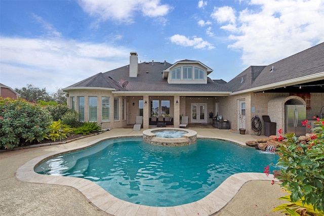 view of swimming pool featuring an in ground hot tub and a patio