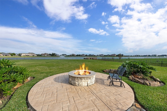 view of patio featuring a water view and an outdoor fire pit