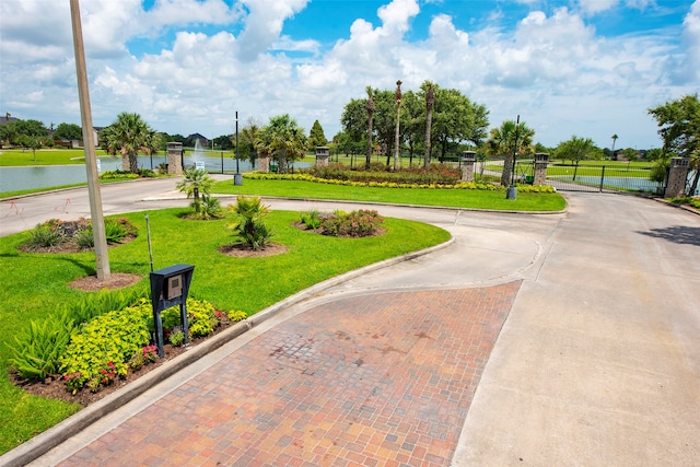 surrounding community featuring a water view and a yard