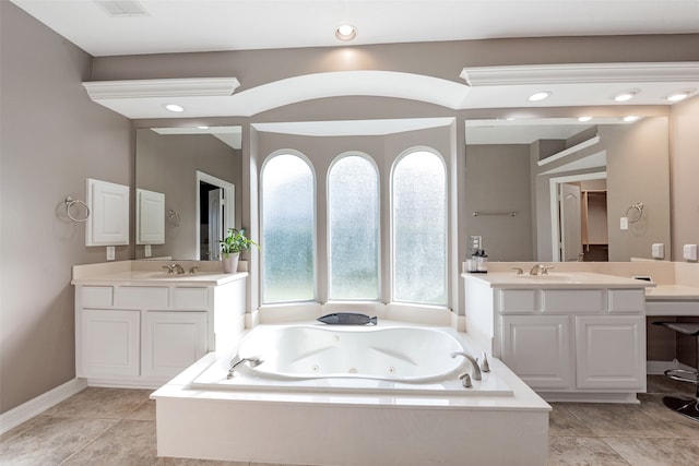 bathroom with tile patterned flooring, vanity, and a tub