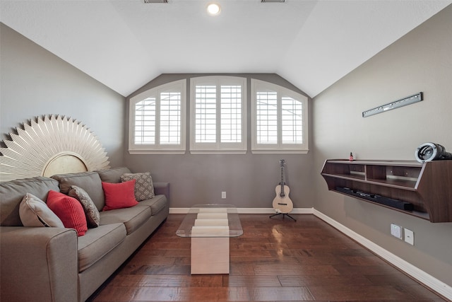 living room featuring dark hardwood / wood-style floors, vaulted ceiling, and a wealth of natural light