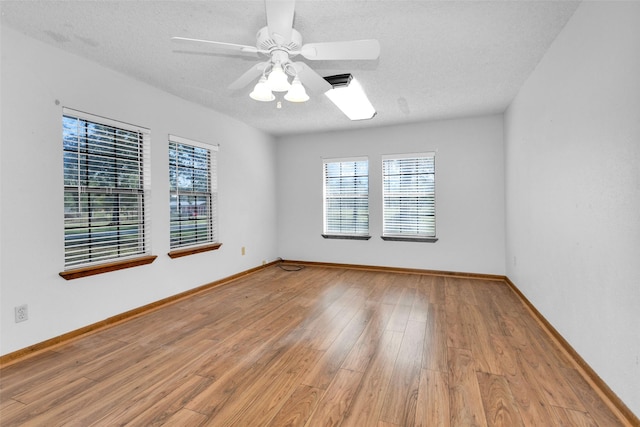 spare room featuring ceiling fan, a textured ceiling, and light hardwood / wood-style flooring