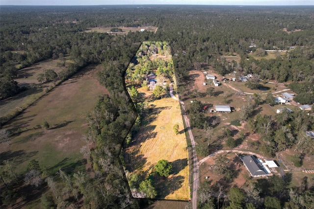 drone / aerial view with a wooded view