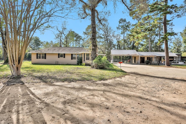 view of front facade with a front lawn and a carport