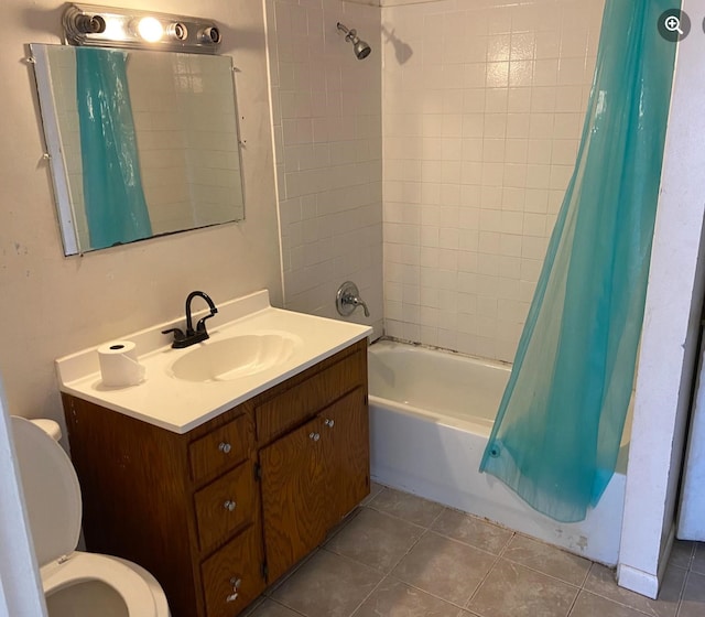 full bathroom with vanity, shower / bath combo, tile patterned flooring, and toilet