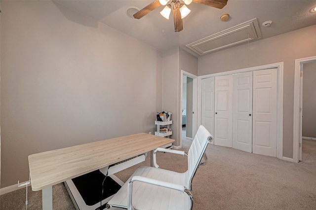 carpeted office space featuring ceiling fan