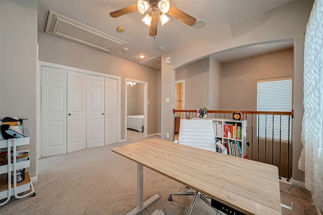 carpeted home office featuring ceiling fan