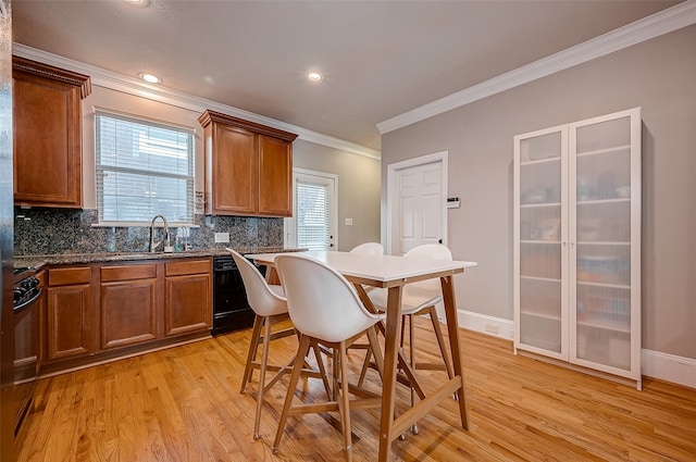 kitchen featuring black appliances, tasteful backsplash, crown molding, sink, and light hardwood / wood-style flooring