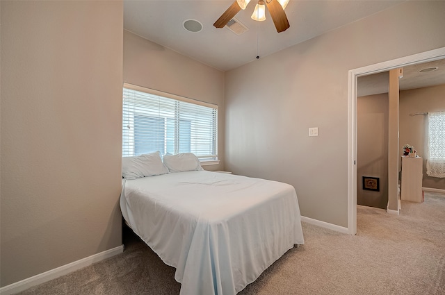 bedroom with ceiling fan and light carpet