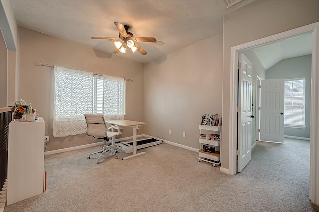 office featuring lofted ceiling, a textured ceiling, light carpet, and ceiling fan