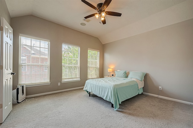 bedroom featuring ceiling fan, vaulted ceiling, and carpet