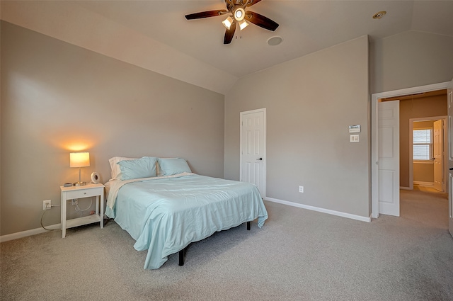 carpeted bedroom with ceiling fan and vaulted ceiling