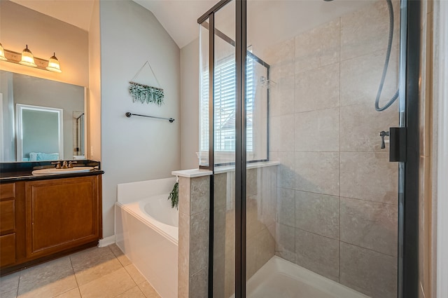 bathroom featuring vanity, lofted ceiling, tile patterned flooring, and separate shower and tub