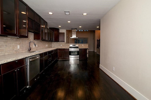 kitchen with dark wood-type flooring, sink, decorative backsplash, appliances with stainless steel finishes, and extractor fan