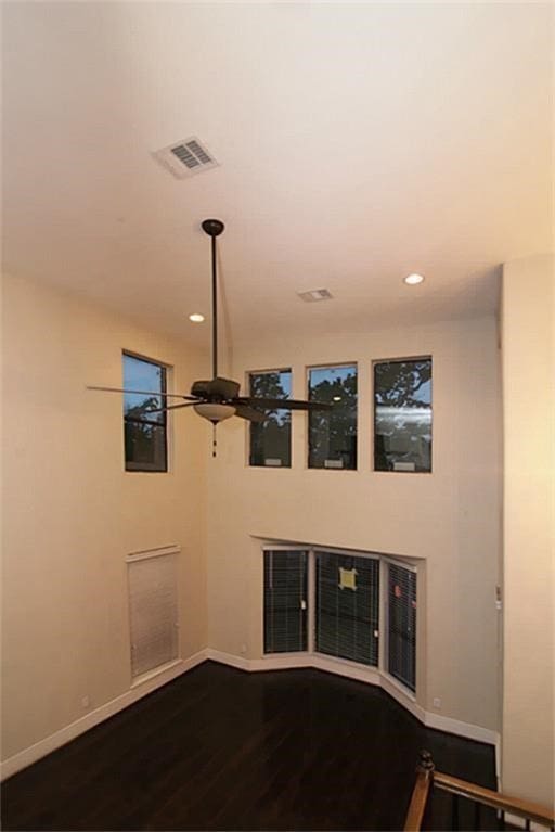 unfurnished living room featuring ceiling fan and hardwood / wood-style flooring