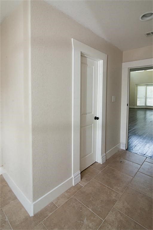 hall with hardwood / wood-style flooring