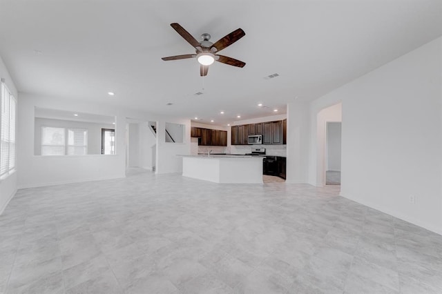 unfurnished living room with ceiling fan