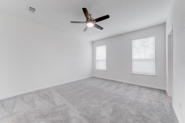 carpeted empty room featuring ceiling fan