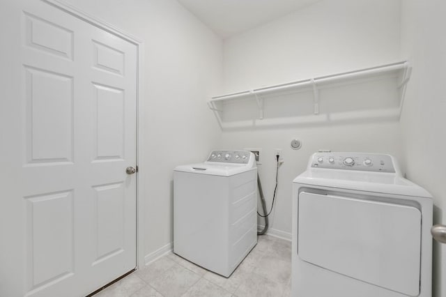 laundry area with washing machine and clothes dryer