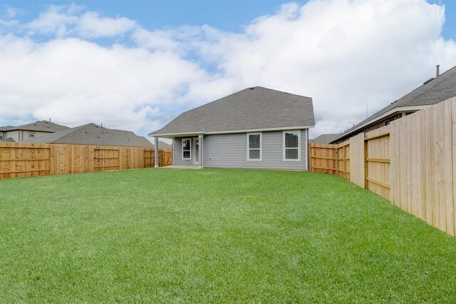 back of house featuring a yard