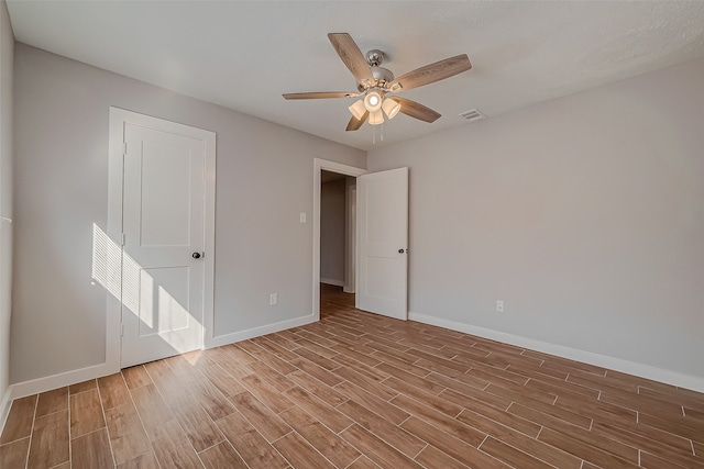 unfurnished bedroom featuring light wood-type flooring and ceiling fan