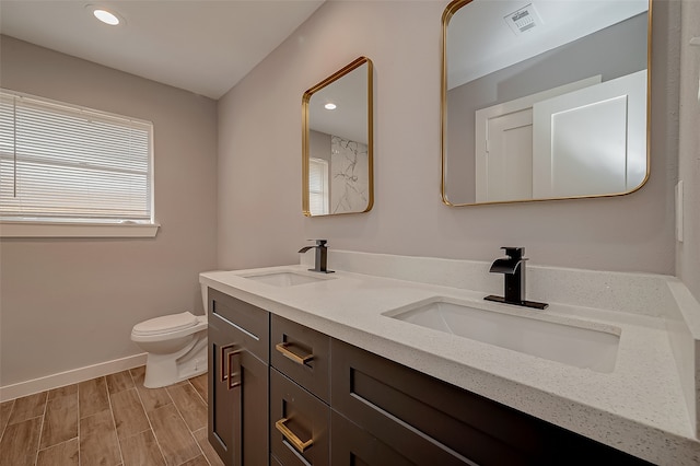 bathroom with vanity, hardwood / wood-style flooring, and toilet